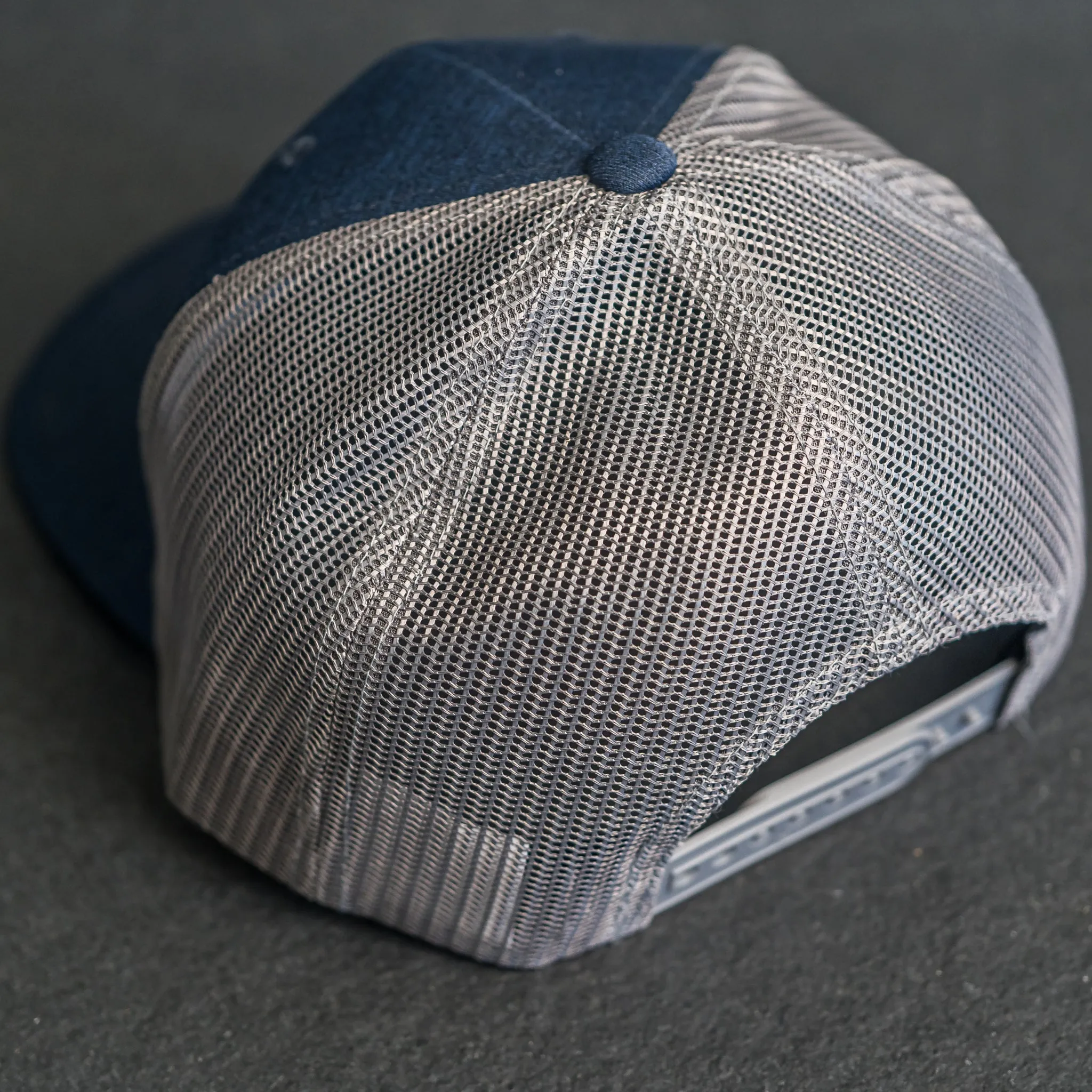 Leather Patch Performance Style Trucker Hat - Wolf Stamp