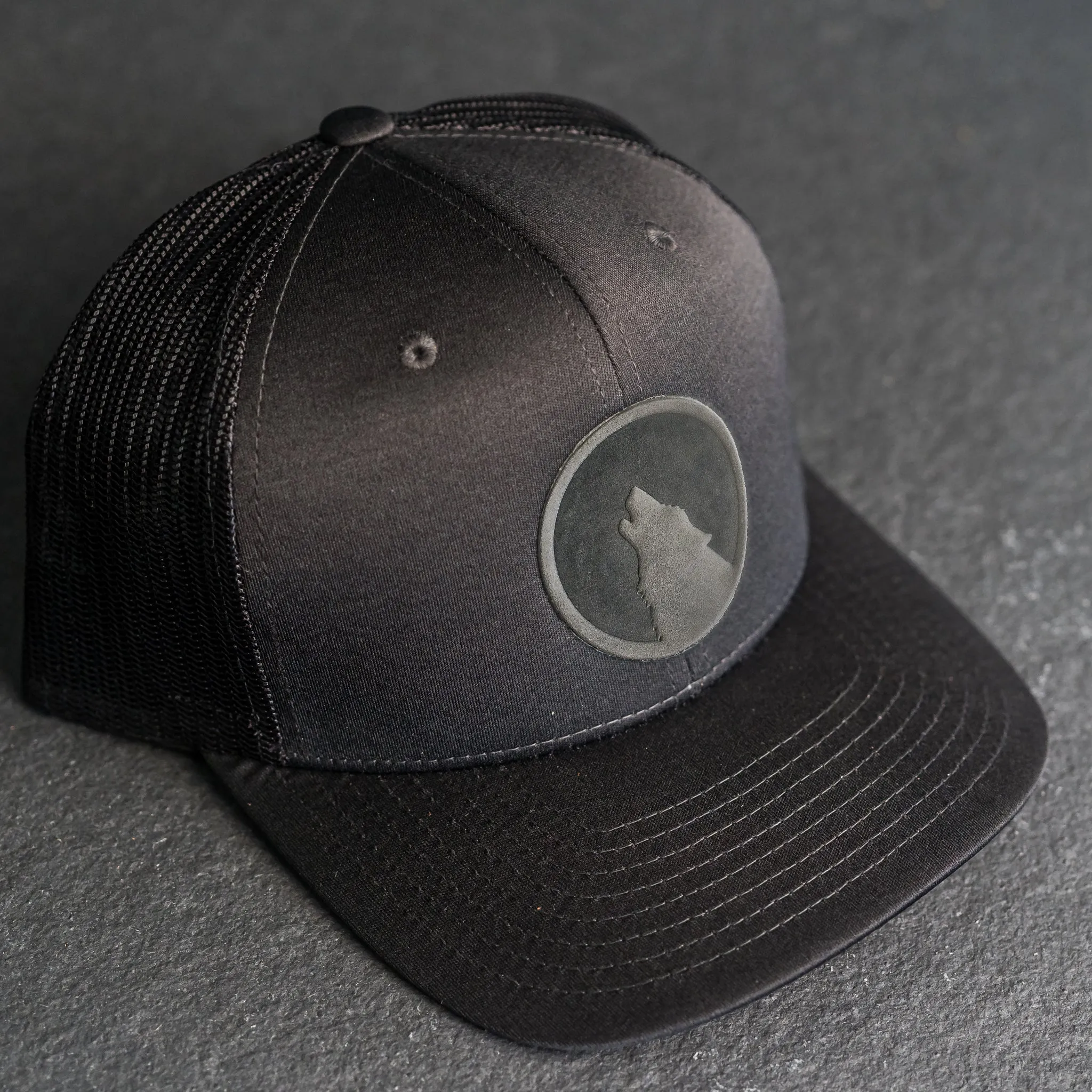 Leather Patch Performance Style Trucker Hat - Wolf Stamp